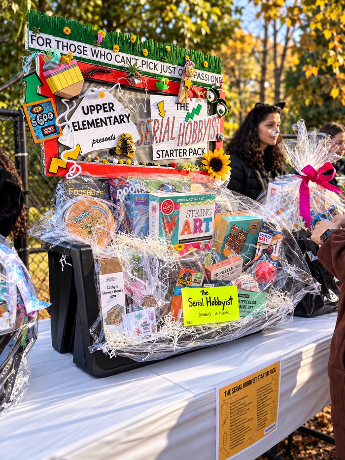 The Serial Hobbyist Starter Pack raffle basket from Upper Elementary, packed with craft kits, puzzles and hobby sets under a handmade sign