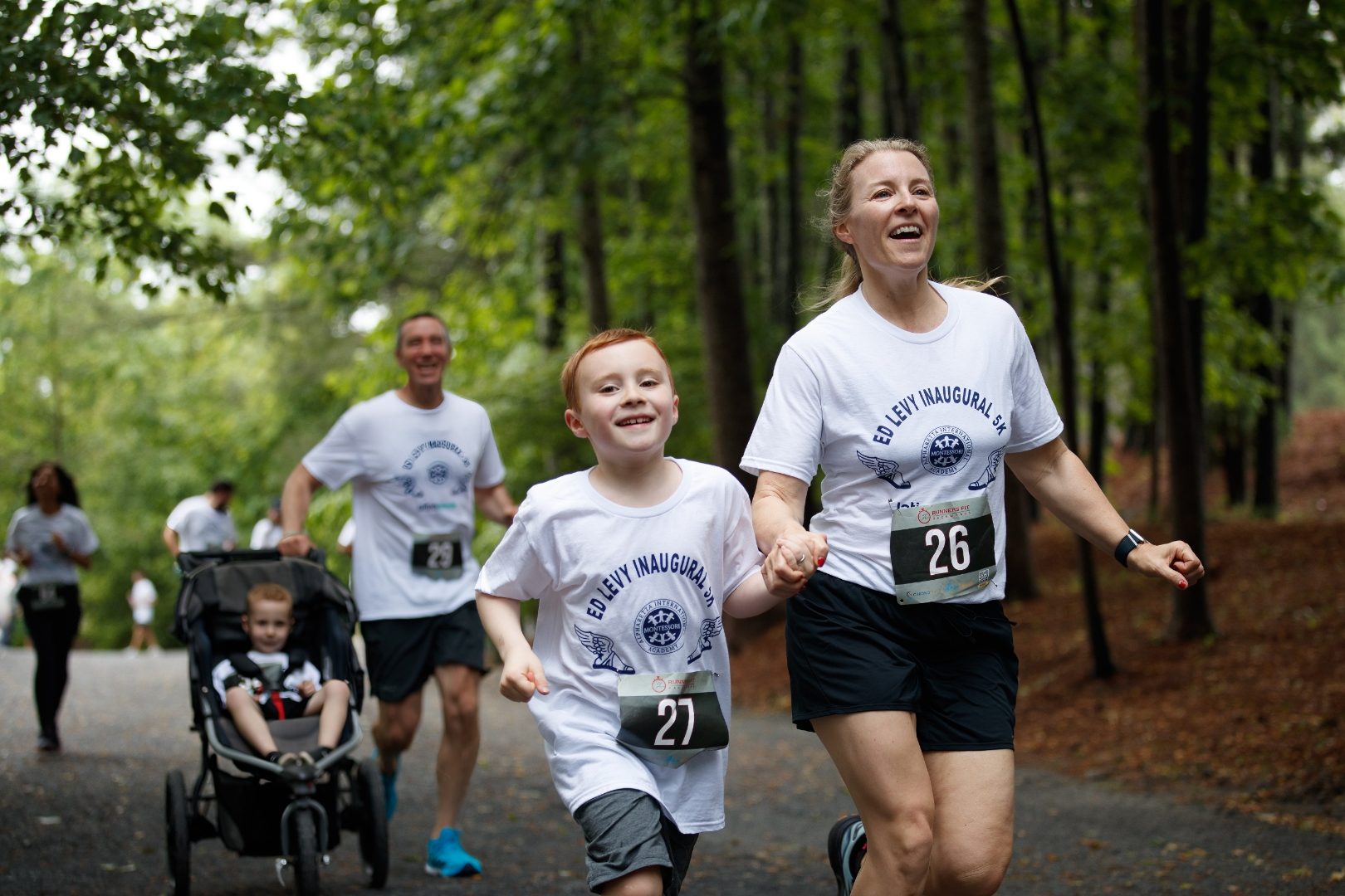 Students, families, and staff running together on the AIA 5K course