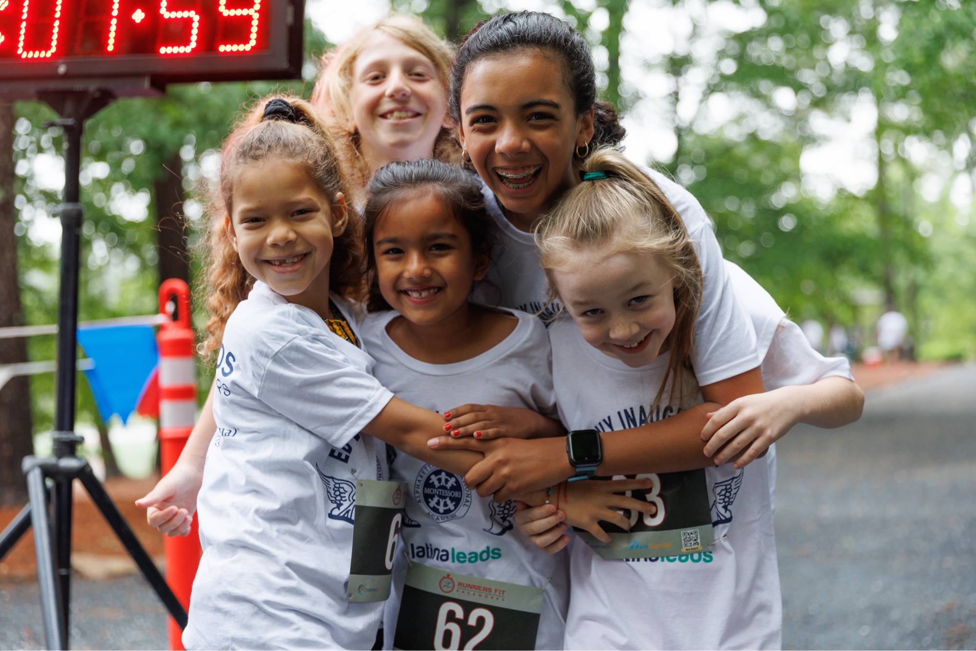 AIA cross country students celebrating together after finishing the annual 5K race