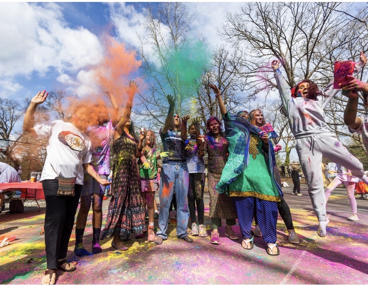 Students celebrating with color powder at International Day