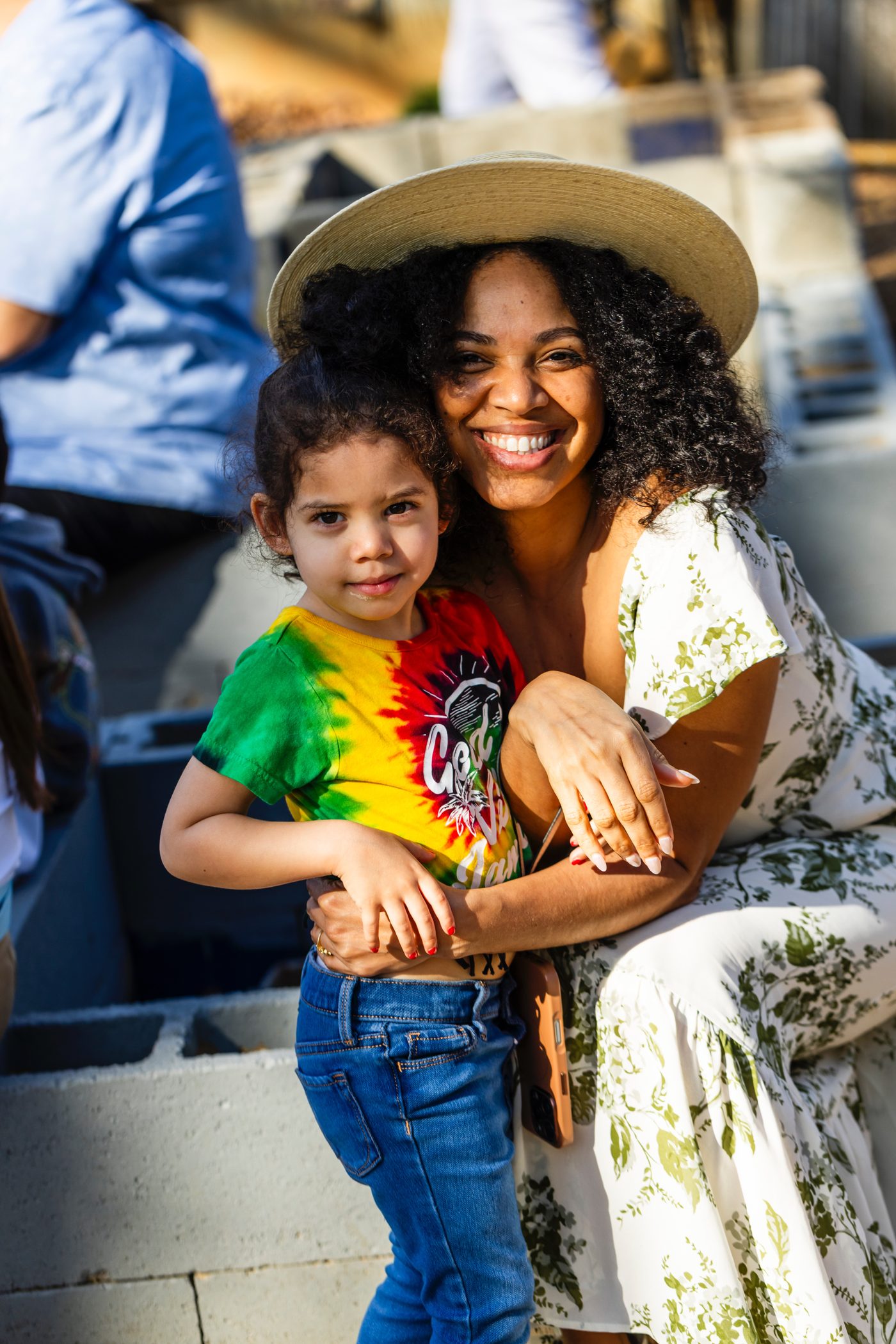 A parent and her daughter together at an AIA community celebration