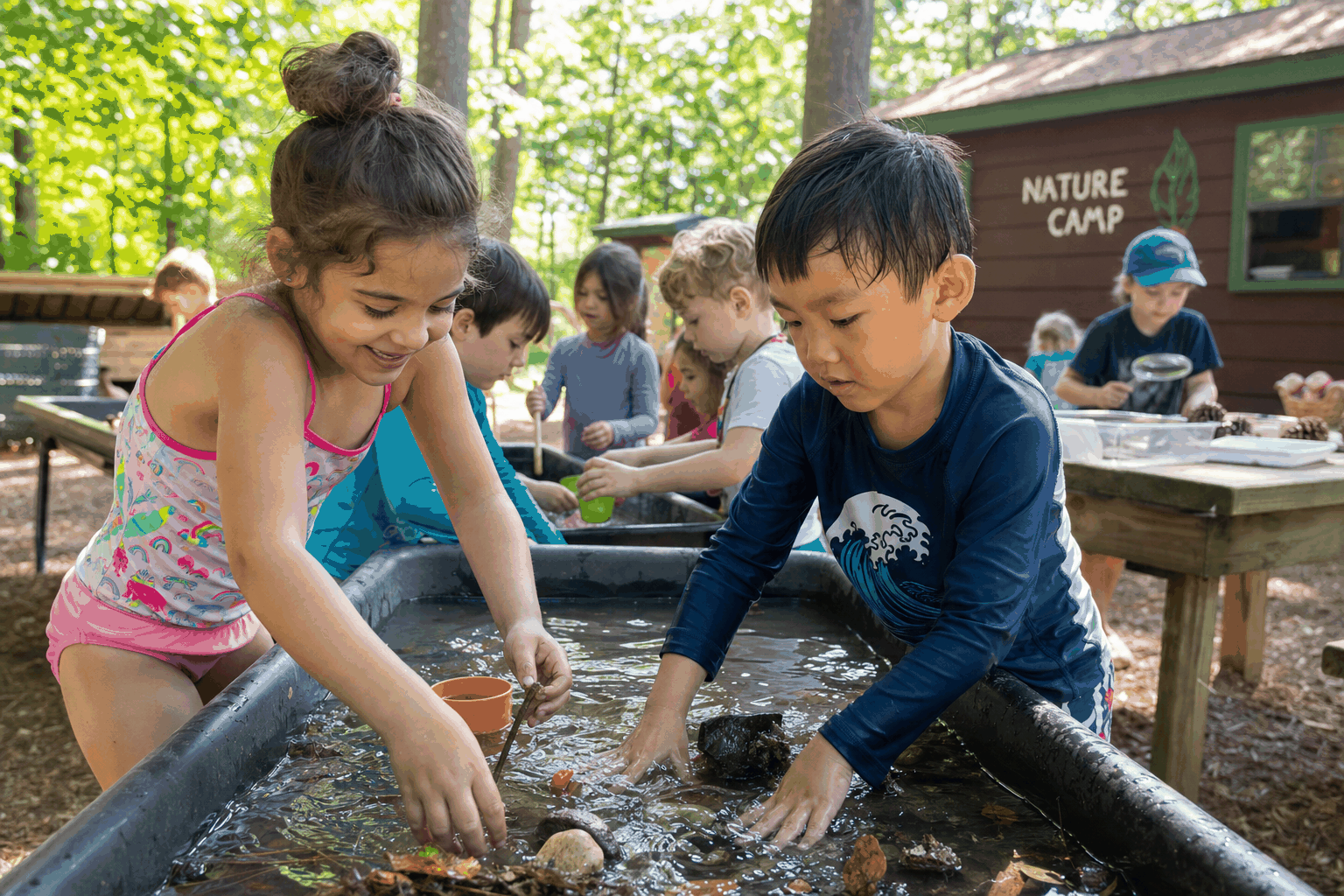 Children exploring at nature-based summer camp activities outdoors